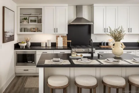 a kitchen with a sink a stove and chairs