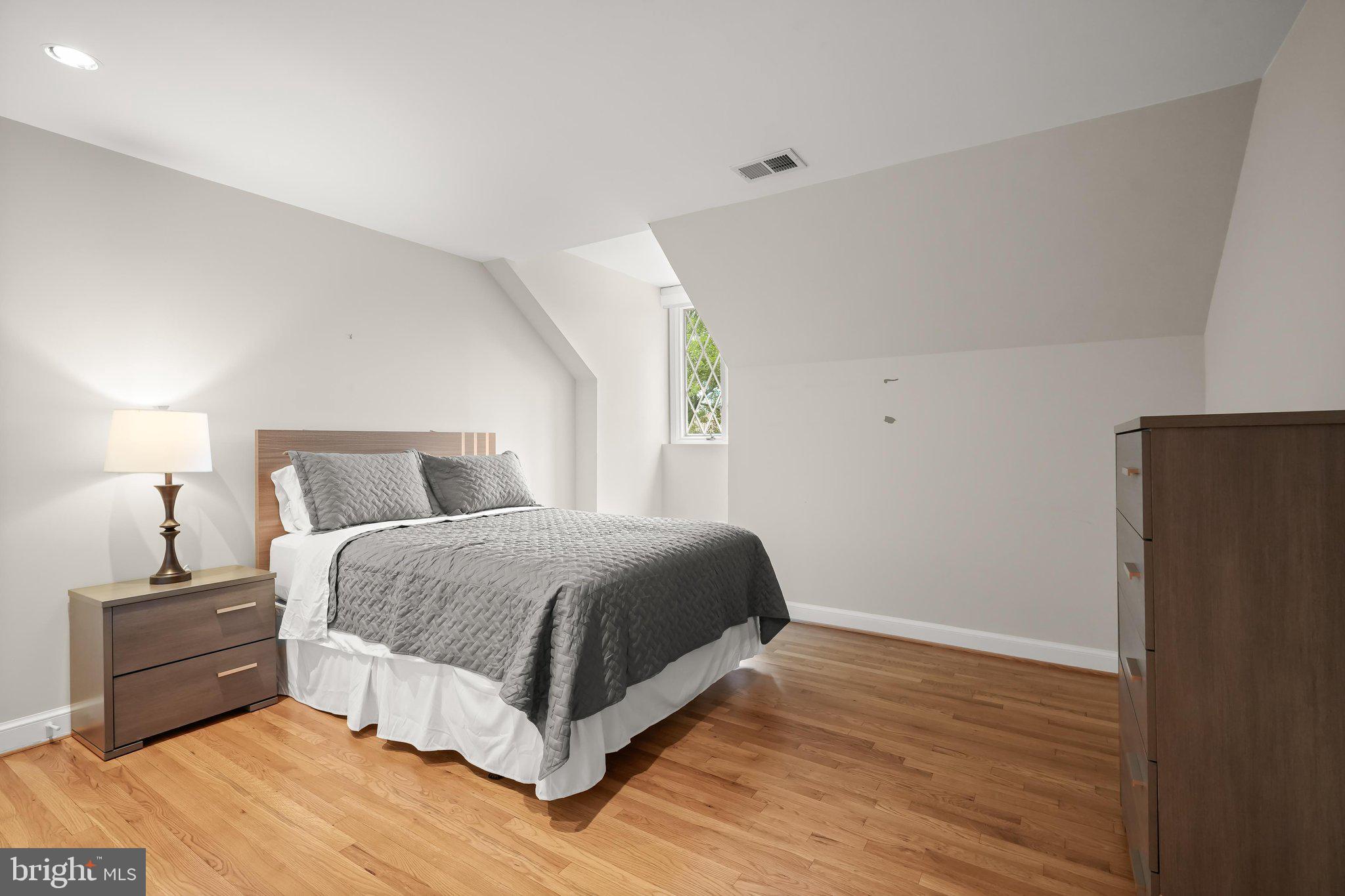 9809 Hall Road Potomac, MD 20854 - Photo 40 of 60 a bedroom with a bed and a night stand