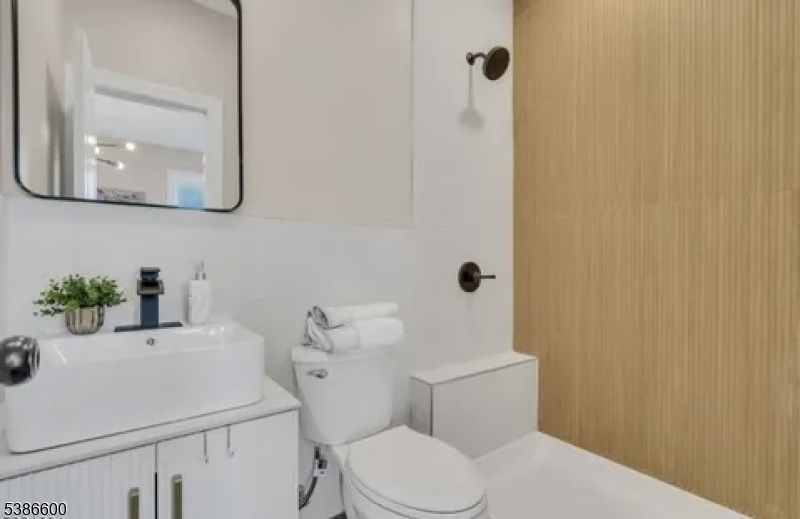 89 Schley Street, Unit 2 Newark, NJ 07112 - Photo 13 of 18 a bathroom with a sink a toilet and mirror