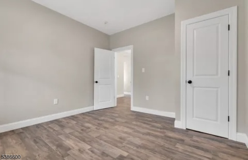 89 Schley Street, Unit 2 Newark, NJ 07112 - Photo 14 of 18 a view of an empty room with wooden floor