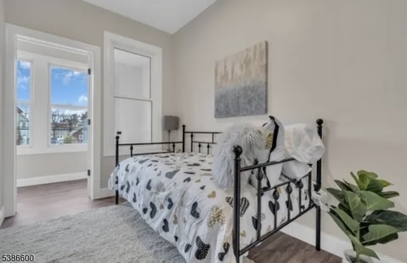 89 Schley Street, Unit 2 Newark, NJ 07112 - Photo 17 of 18 a bed room with furniture and wooden floor