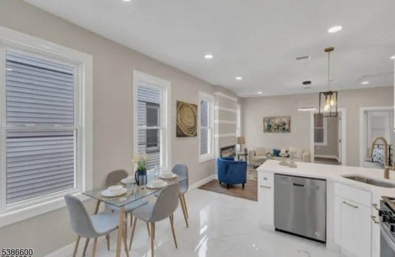 89 Schley Street, Unit 2 Newark, NJ 07112 - Photo 4 of 18 a living room with furniture a dining table and chairs