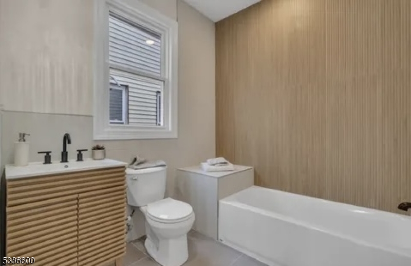 89 Schley Street, Unit 2 Newark, NJ 07112 - Photo 7 of 18 a bathroom with a sink a toilet and a bathtub