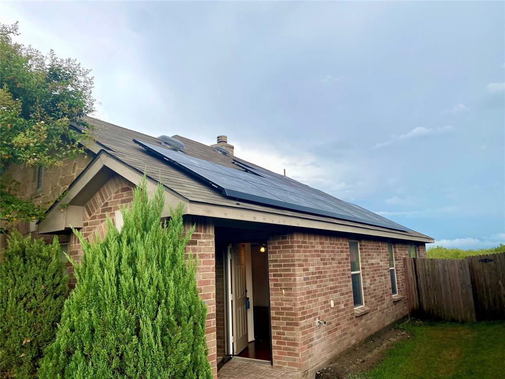 2533 Grand Gulf Road Fort Worth, TX 76123 - Photo 2 of 13 Back of house with solar panels, brick siding, and a chimney