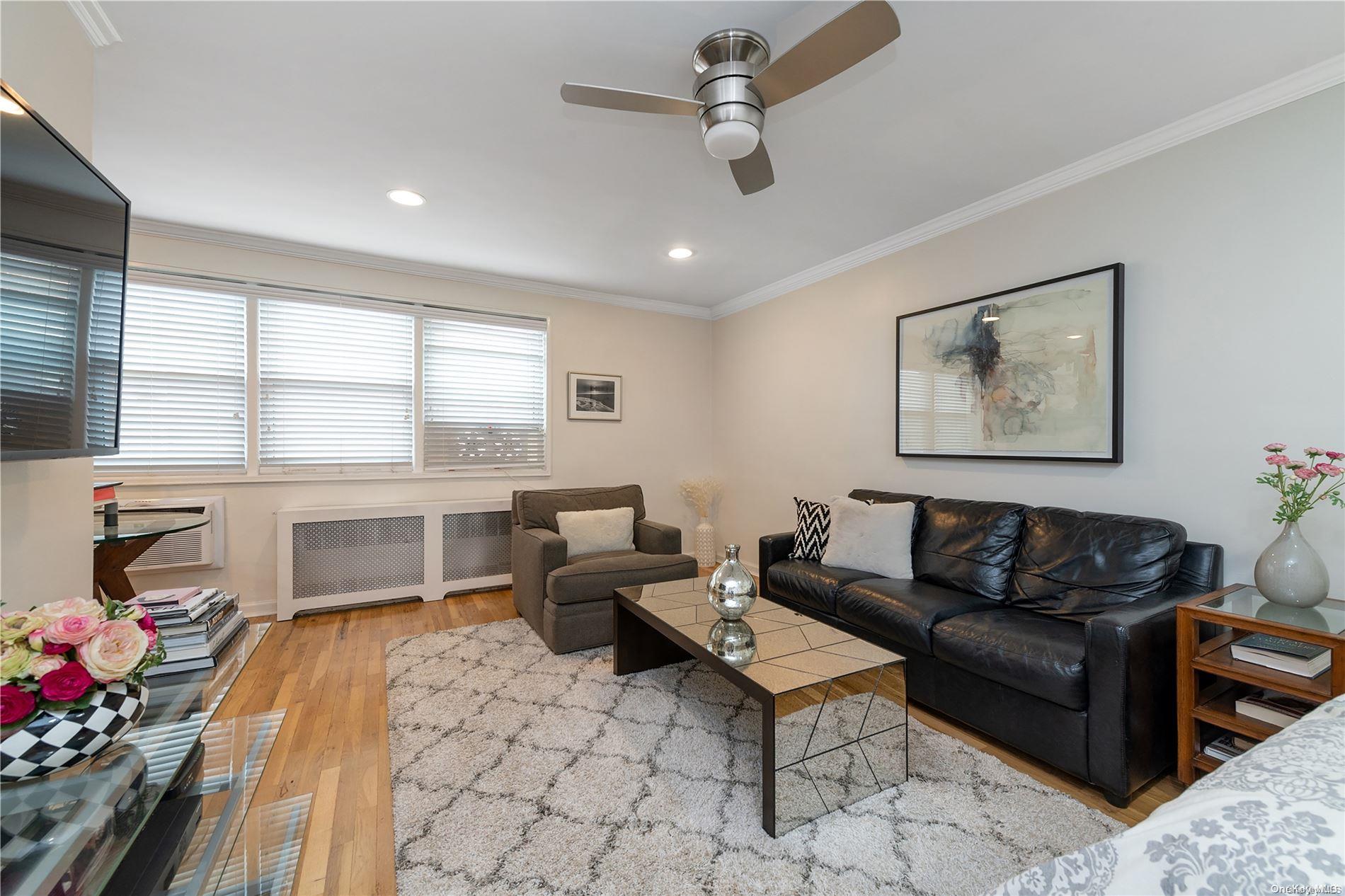 16 Canterbury Road, Unit 3B Great Neck, NY 11021 - Photo 1 of 1 a living room with furniture and a table