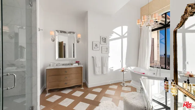 a bathroom with a granite countertop sink a mirror and shower