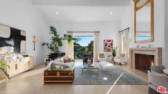 a living room with fireplace furniture and a flat screen tv