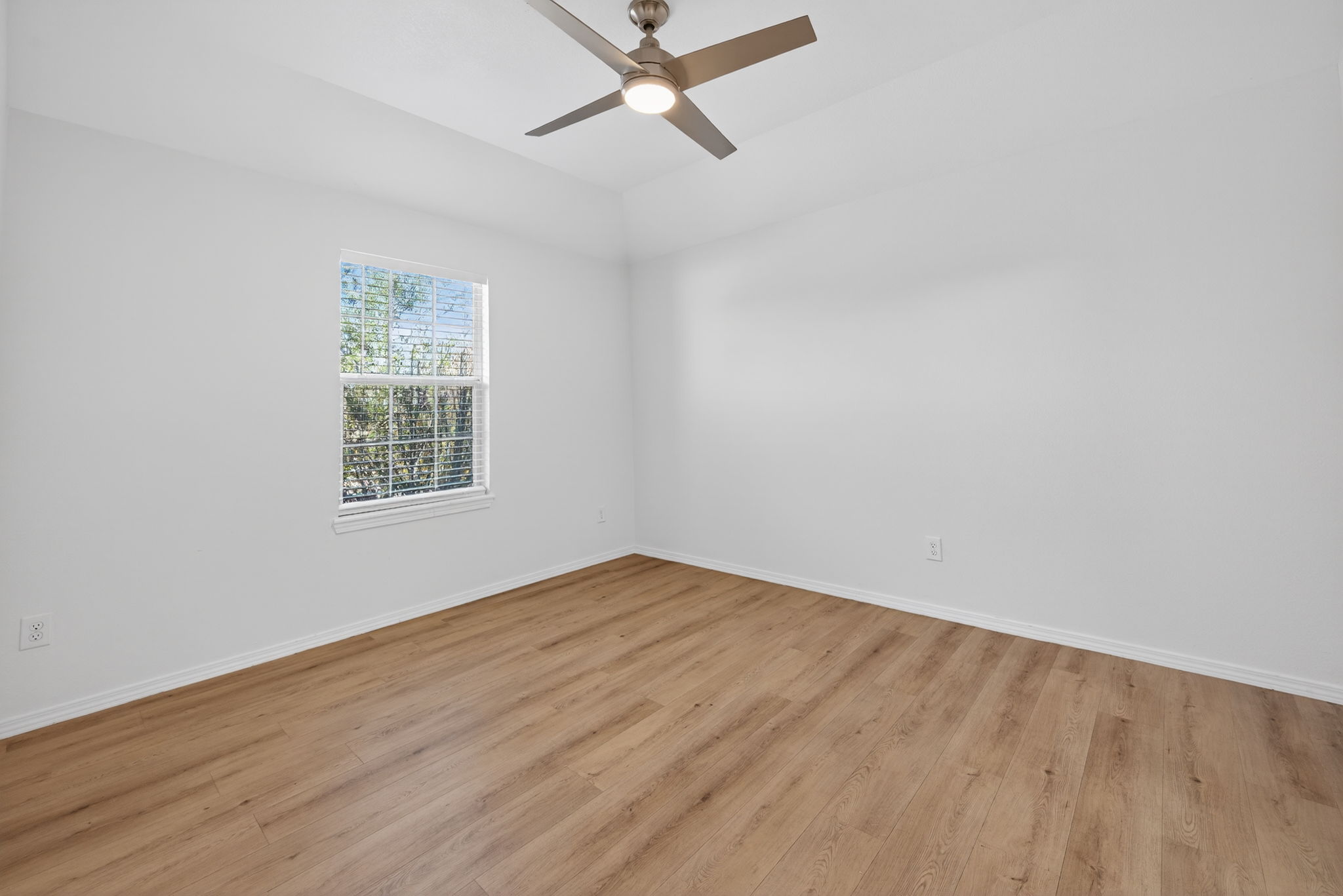 2305 Gavin Trail Pflugerville, TX 78660 - Photo 26 of 40 an empty room with wooden floor and windows