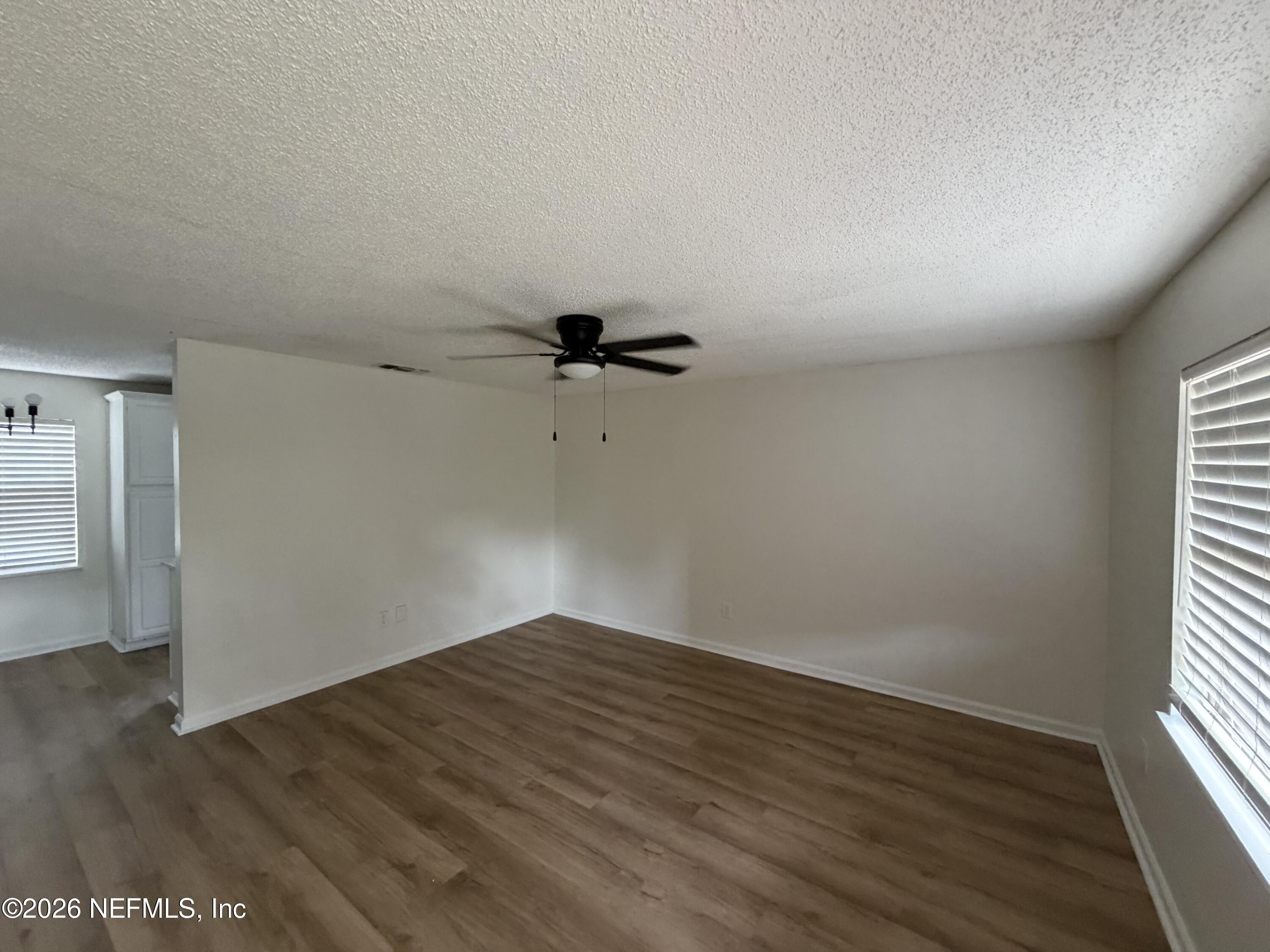 7539 Walden Road Jacksonville, FL 32244 - Photo 18 of 18 an empty room with wooden floor and windows