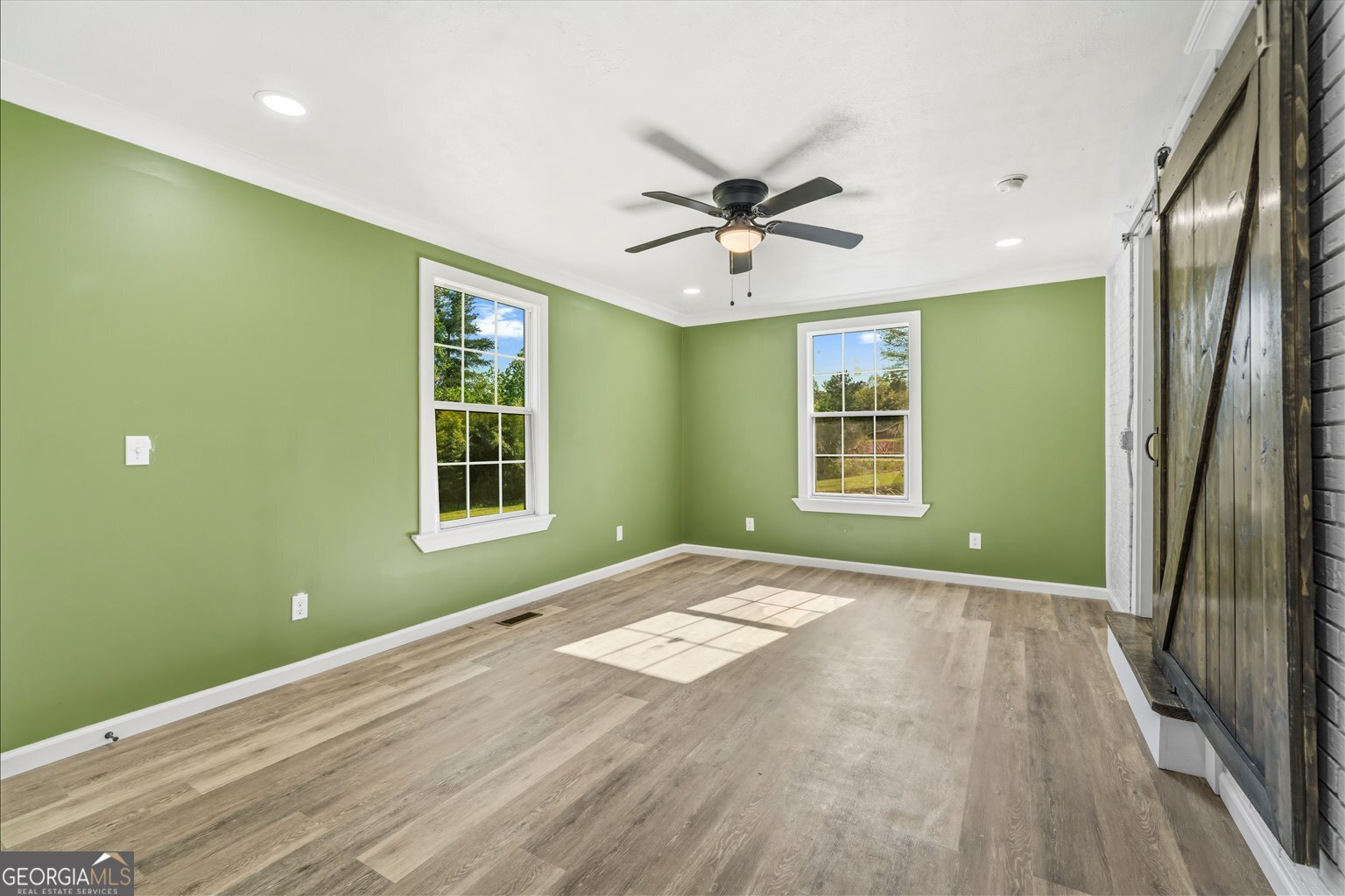 832 Snow Springs Road Northwest Adairsville, GA 30103 - Photo 14 of 35 a view of an empty room with a window and wooden floor