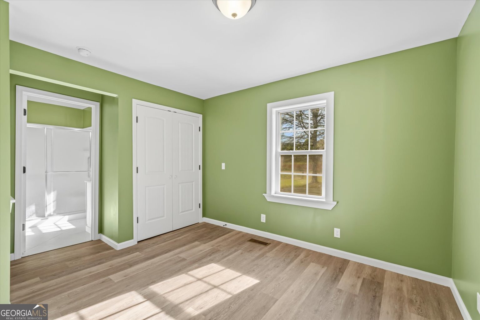 832 Snow Springs Road Northwest Adairsville, GA 30103 - Photo 19 of 35 a view of an empty room with window and wooden floor