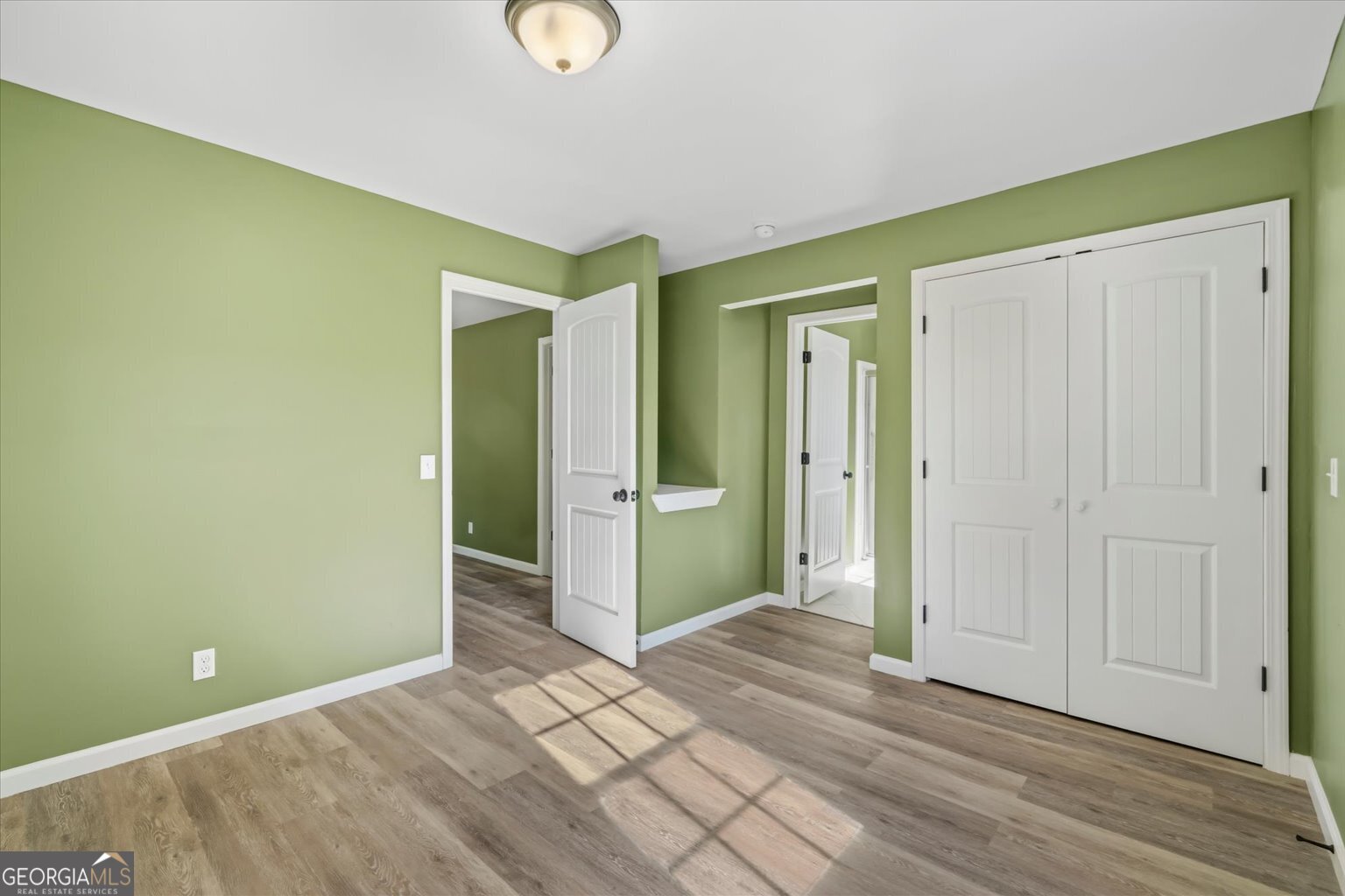 832 Snow Springs Road Northwest Adairsville, GA 30103 - Photo 20 of 35 an empty room with closet and wooden floor