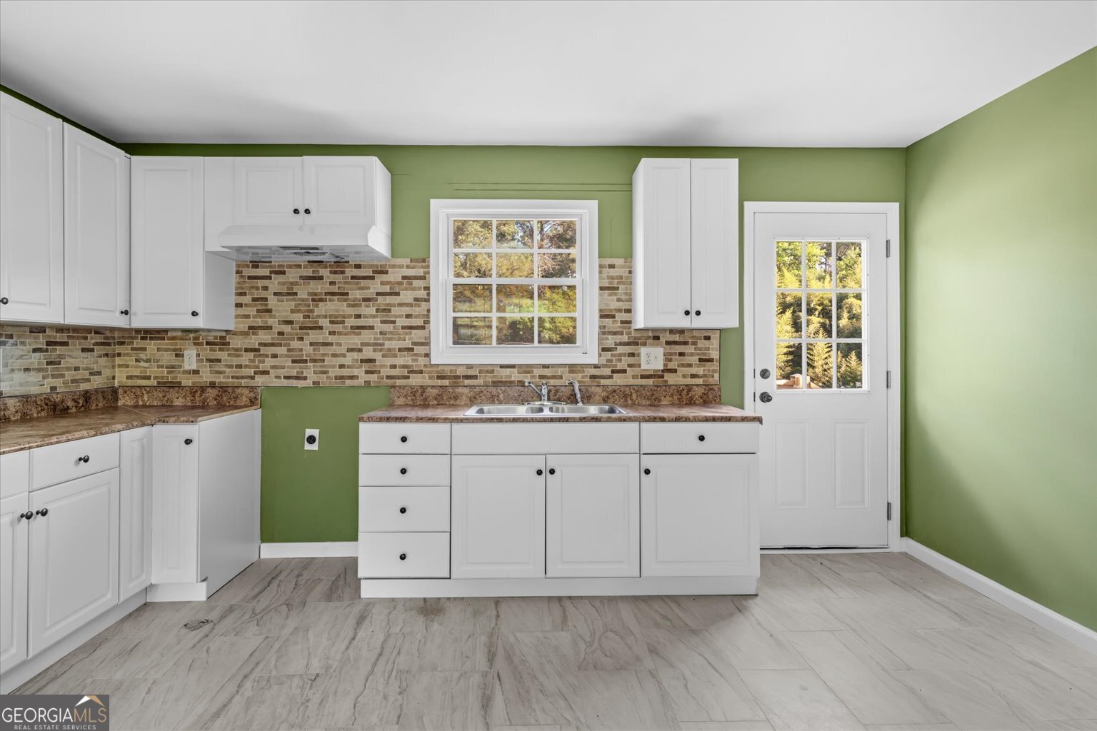 832 Snow Springs Road Northwest Adairsville, GA 30103 - Photo 24 of 35 a kitchen with cabinets wooden floor and a window