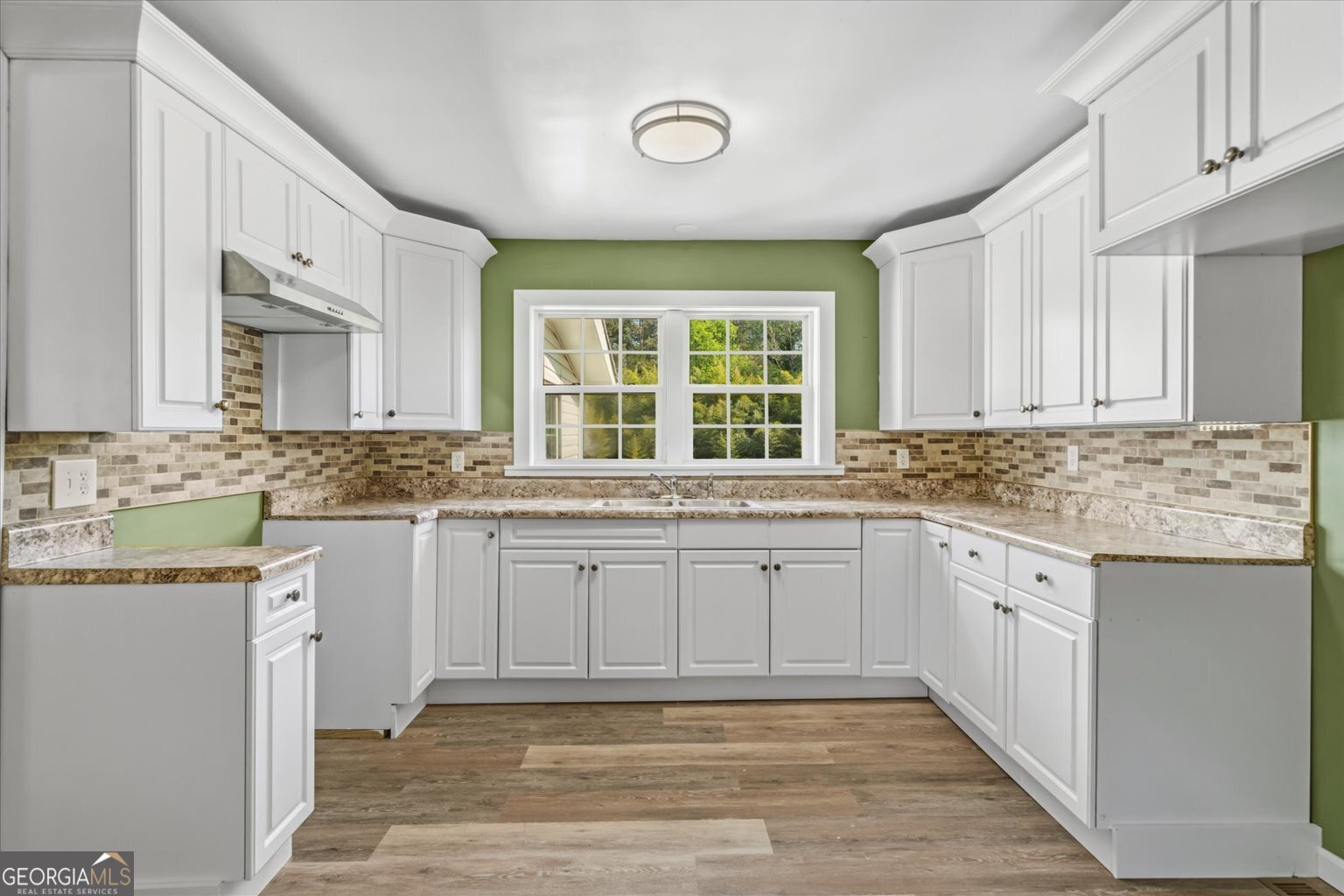 832 Snow Springs Road Northwest Adairsville, GA 30103 - Photo 7 of 35 a large kitchen with granite countertop a sink and cabinets