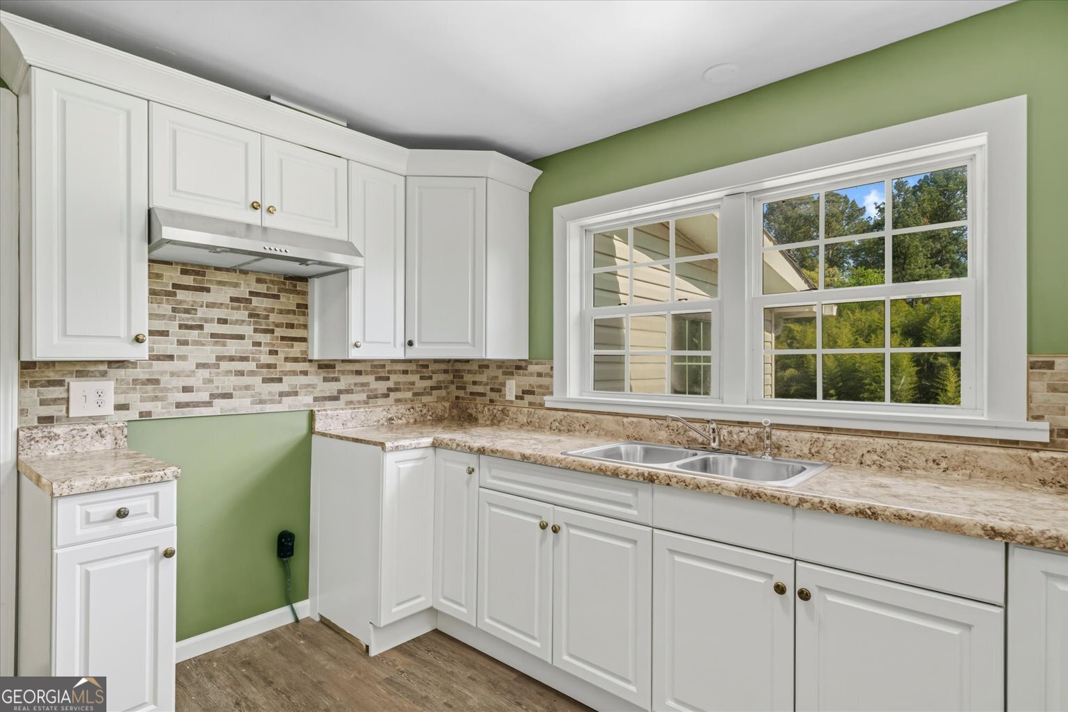 832 Snow Springs Road Northwest Adairsville, GA 30103 - Photo 8 of 35 a kitchen with granite countertop white cabinets and a window