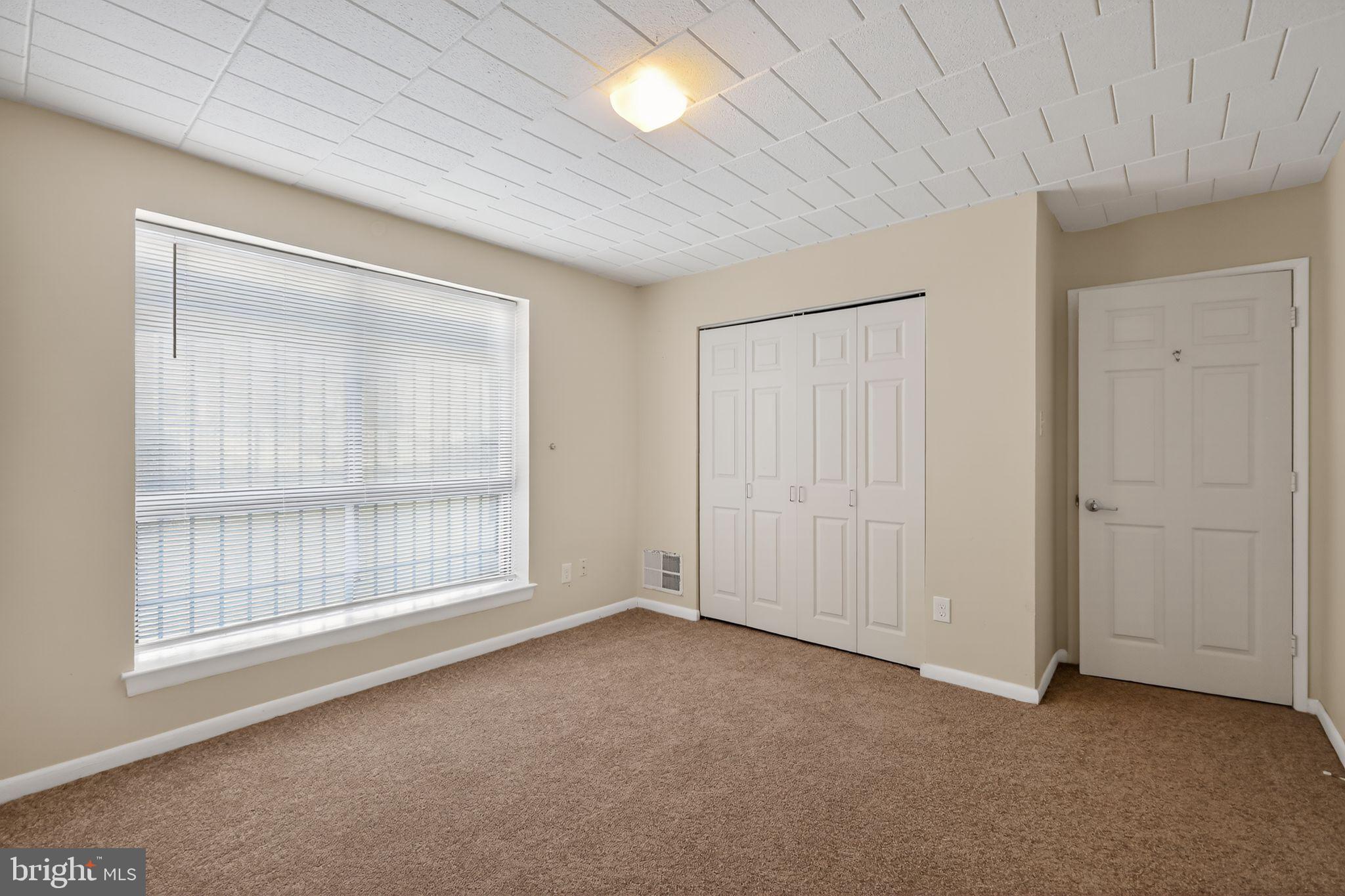 1619 Gainesville Street Southeast, Unit T Washington, DC 20020 - Photo 11 of 14 an empty room with windows