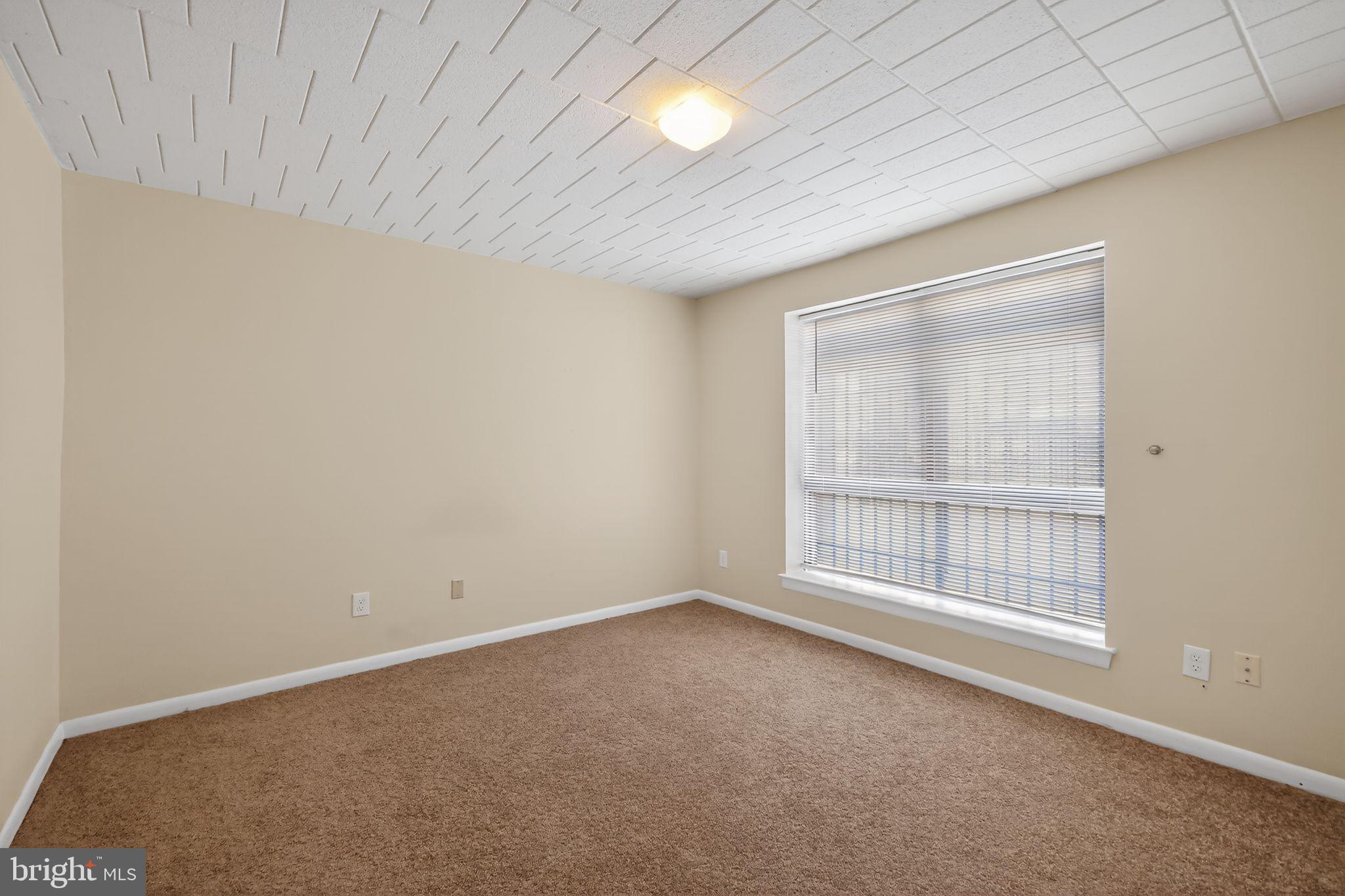 1619 Gainesville Street Southeast, Unit T Washington, DC 20020 - Photo 4 of 14 an empty room with windows