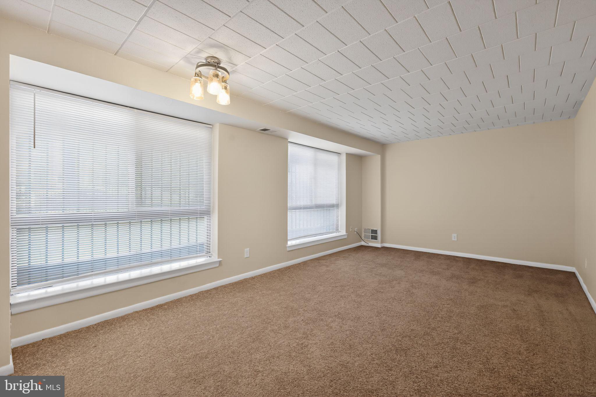 1619 Gainesville Street Southeast, Unit T Washington, DC 20020 - Photo 6 of 14 a view of an empty room with a window