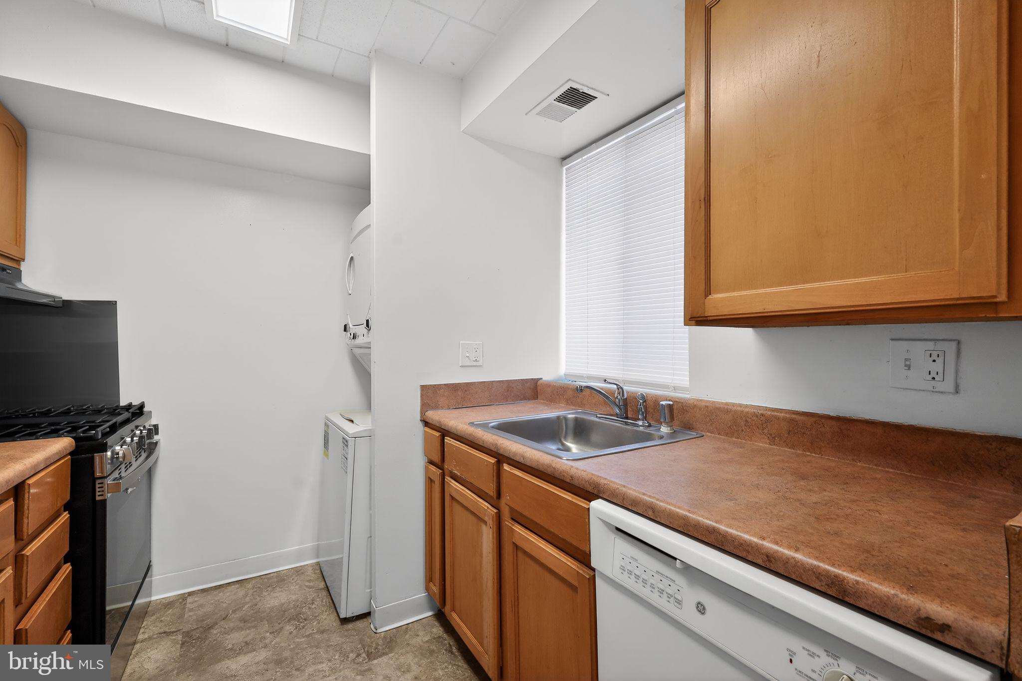 1619 Gainesville Street Southeast, Unit T Washington, DC 20020 - Photo 8 of 14 a kitchen with a sink and a microwave