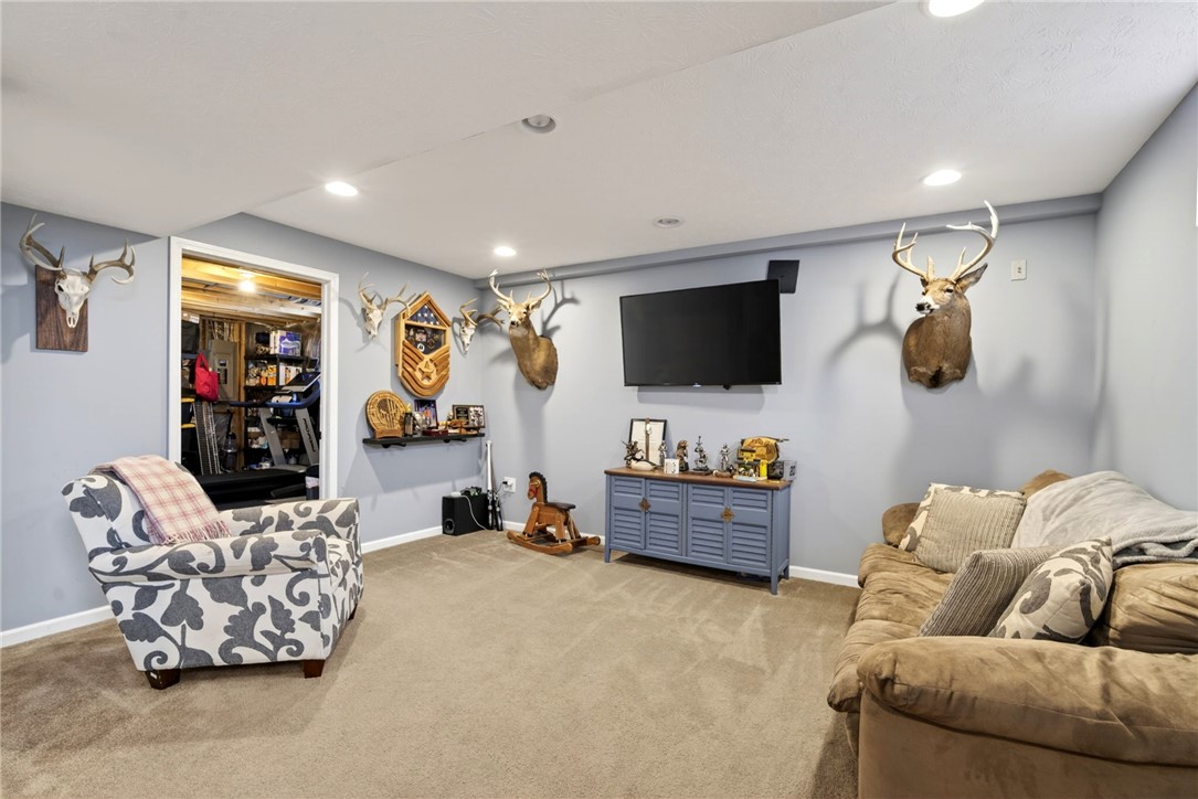 39 Holly Court Springboro, OH 45066 - Photo 28 of 42 This versatile recreation room features soft carpeting and recessed lighting, creating an inviting space for relaxation.