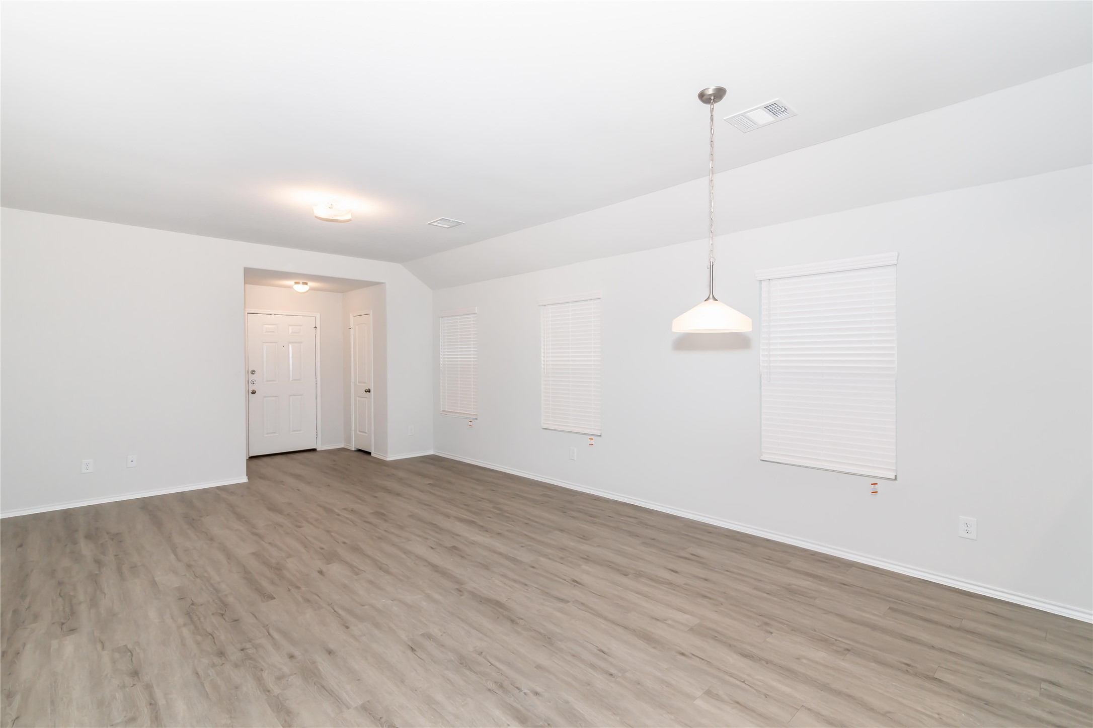 2268 Onyx Lane Conroe, TX 77301 - Photo 7 of 17 a view of an empty room with wooden floor and windows