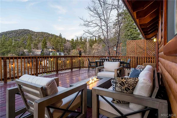 a view of a patio with couches chairs and wooden floor