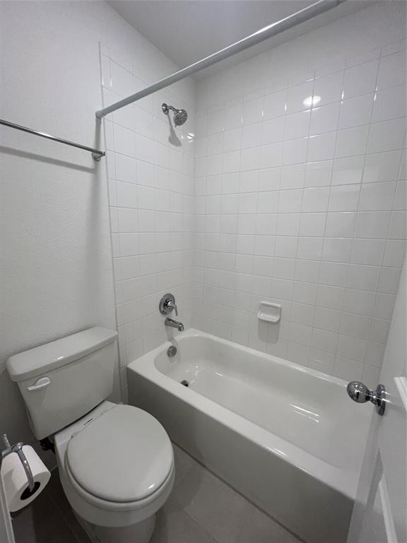 3708 Queen Road Sherman, TX 75090 - Photo 23 of 30 Bathroom featuring toilet, tile flooring, and tiled shower / bath combo