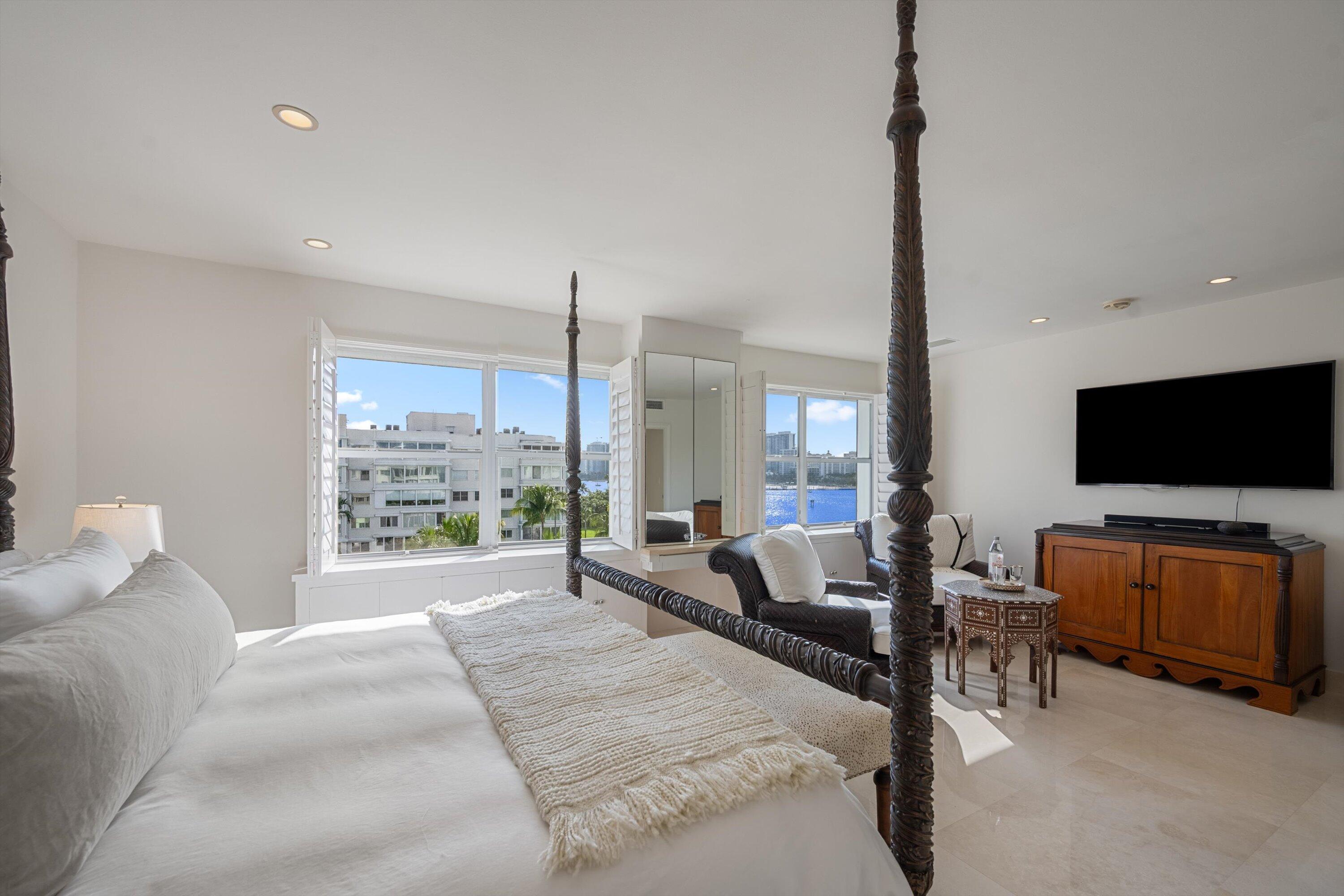 44 Cocoanut Row, Unit 514A Palm Beach, FL 33480 - Photo 12 of 36 a large bedroom with a large bed and flat tv screen