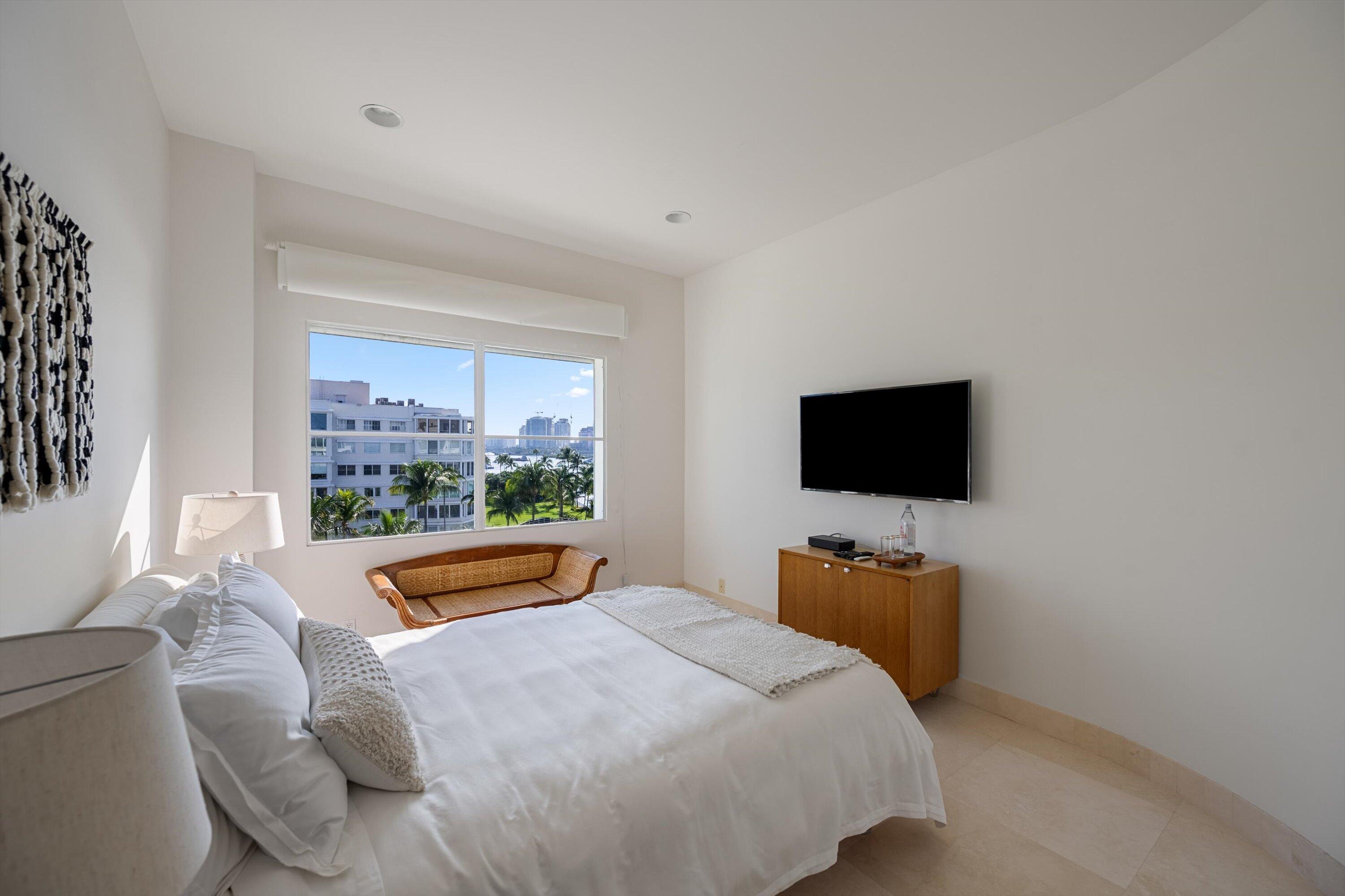 44 Cocoanut Row, Unit 514A Palm Beach, FL 33480 - Photo 16 of 36 a bedroom with a bed and flat screen tv