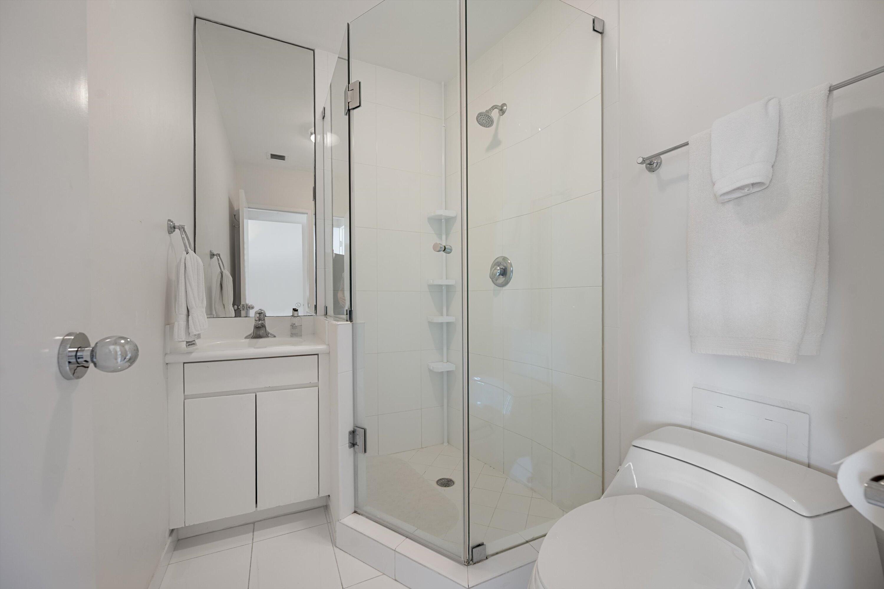 44 Cocoanut Row, Unit 514A Palm Beach, FL 33480 - Photo 19 of 36 a bathroom with a shower a toilet and sink