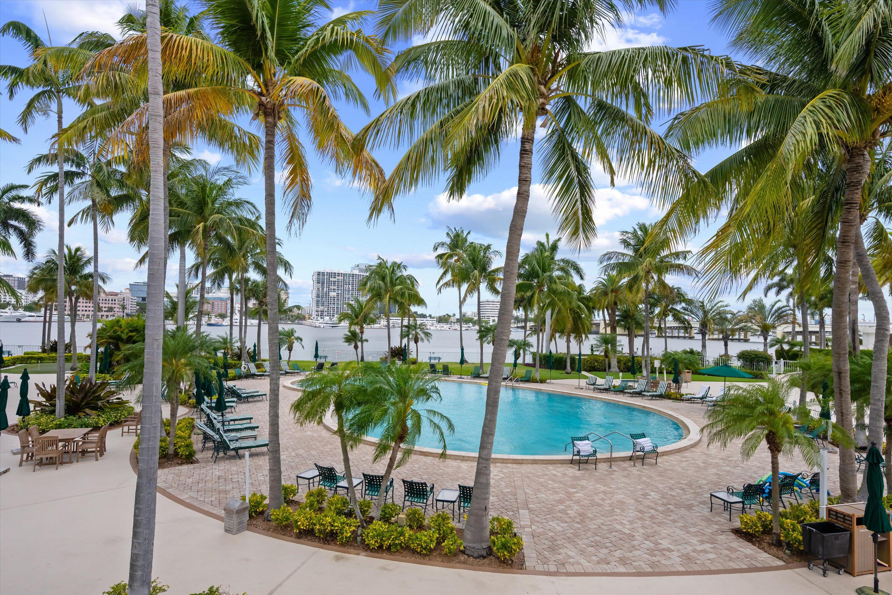 44 Cocoanut Row, Unit 514A Palm Beach, FL 33480 - Photo 31 of 36 a swimming pool with outdoor seating and a yard