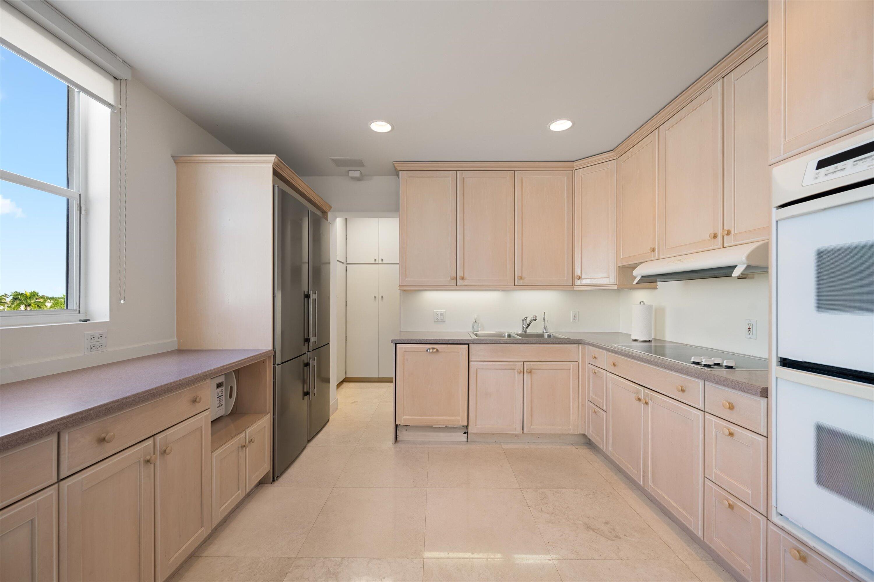 44 Cocoanut Row, Unit 514A Palm Beach, FL 33480 - Photo 7 of 36 a kitchen with granite countertop white cabinets white stainless steel appliances and sink