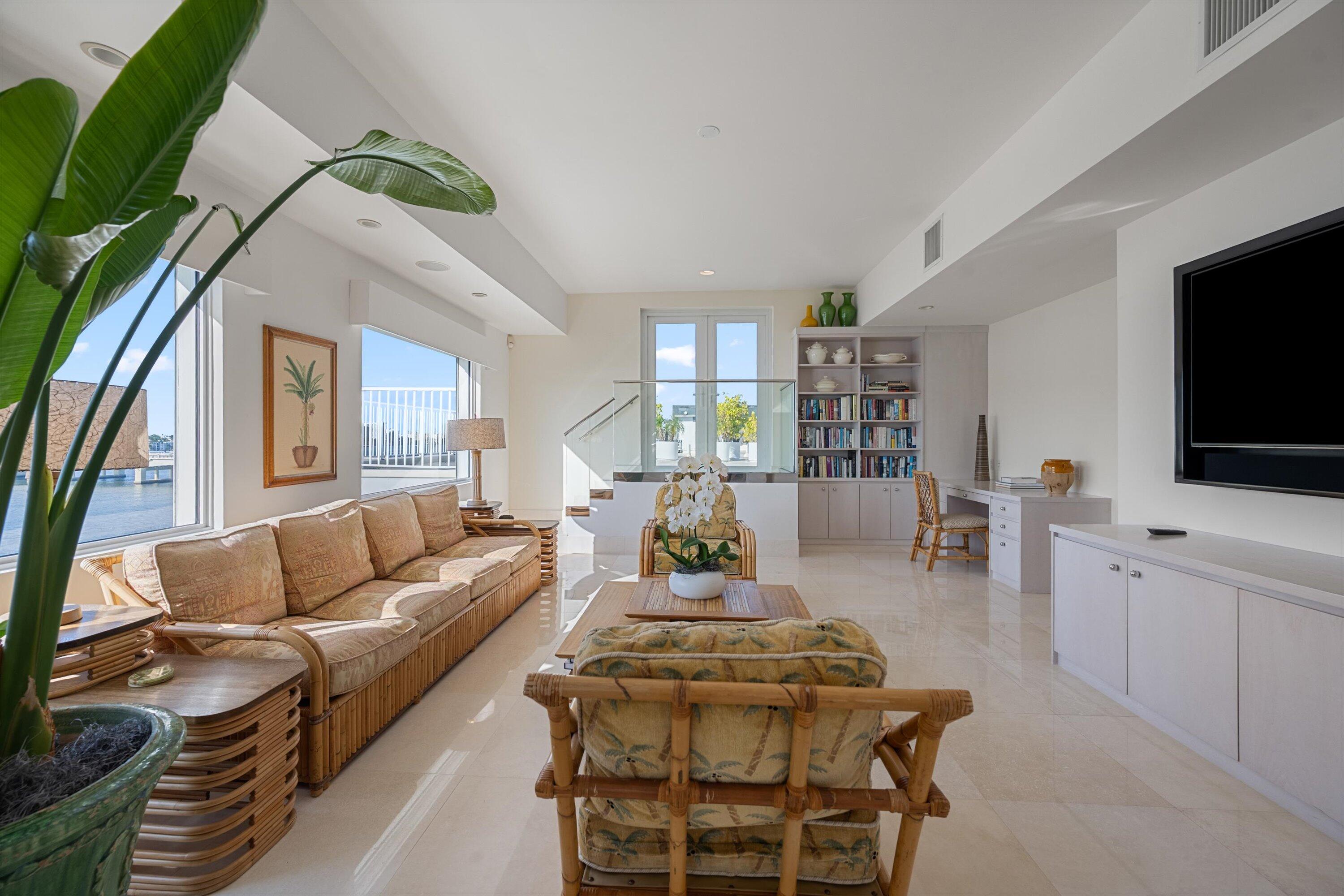 44 Cocoanut Row, Unit 514A Palm Beach, FL 33480 - Photo 10 of 36 a living room with furniture a flat screen tv and a floor to ceiling window