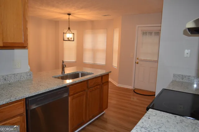 a kitchen with sink cabinets and wooden floor
