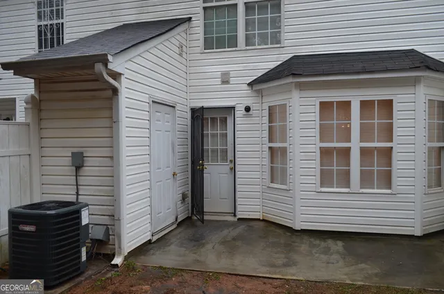 a view of a house with more windows and brick wall
