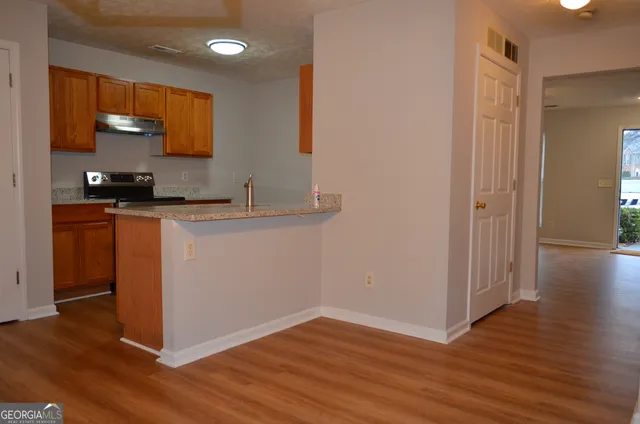 a kitchen with wooden floor and a sink