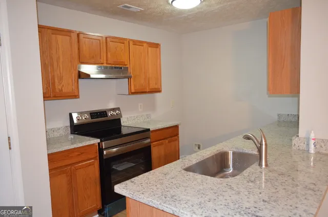 a kitchen with a sink cabinets and appliances