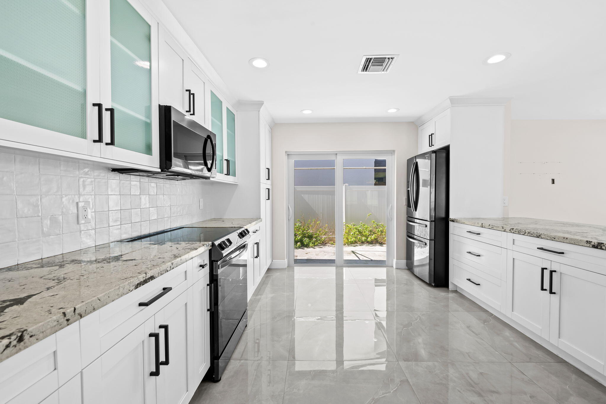 23162 L'Ermitage Circle Boca Raton, FL 33433 - Photo 12 of 48 a kitchen with stainless steel appliances granite countertop a refrigerator a stove top oven a sink and dishwasher