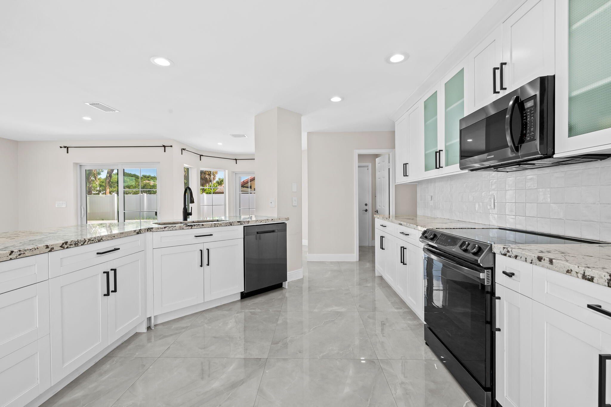 23162 L'Ermitage Circle Boca Raton, FL 33433 - Photo 13 of 48 a kitchen with stainless steel appliances granite countertop a stove top oven a sink and dishwasher