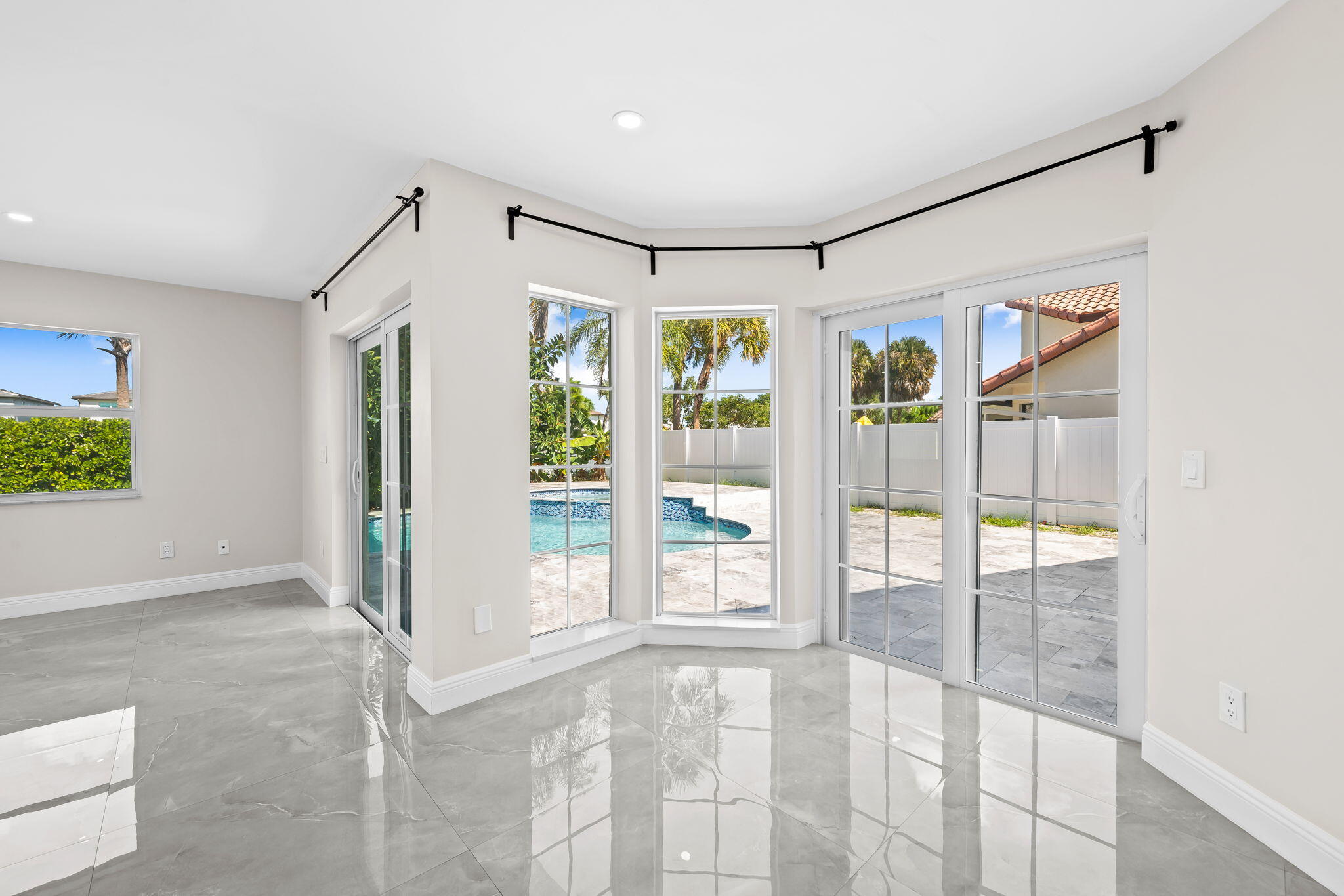 23162 L'Ermitage Circle Boca Raton, FL 33433 - Photo 15 of 48 a view of an empty room with a glass door