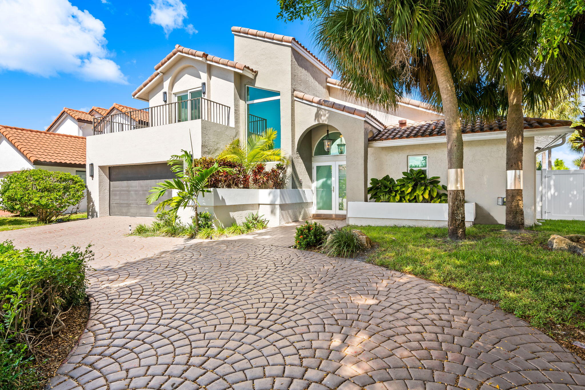 23162 L'Ermitage Circle Boca Raton, FL 33433 - Photo 2 of 48 a front view of a house with a garden and plants