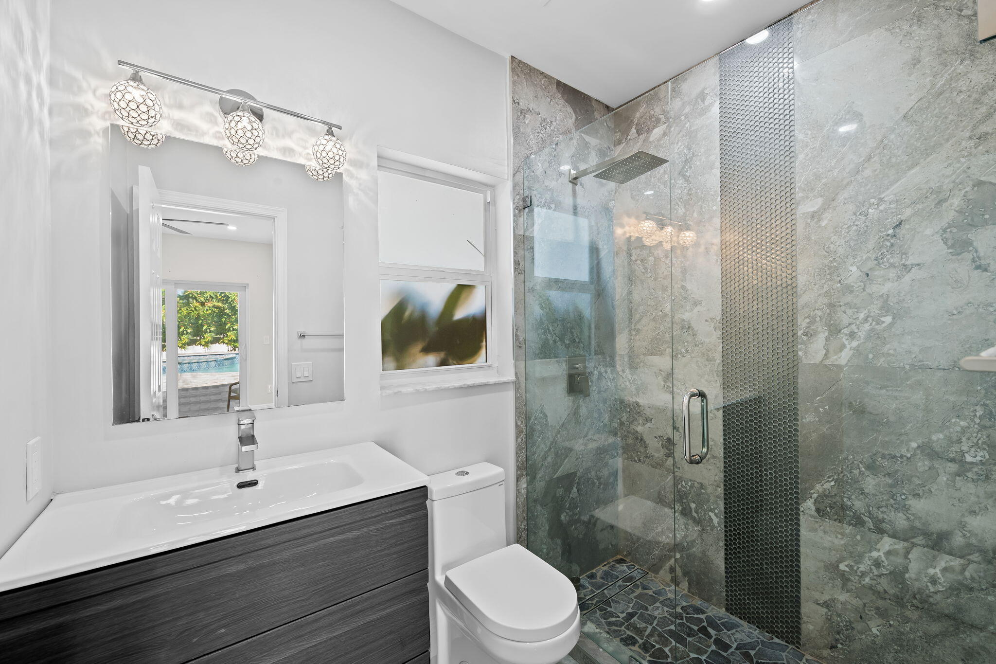 23162 L'Ermitage Circle Boca Raton, FL 33433 - Photo 23 of 48 a bathroom with a sink toilet a mirror and shower