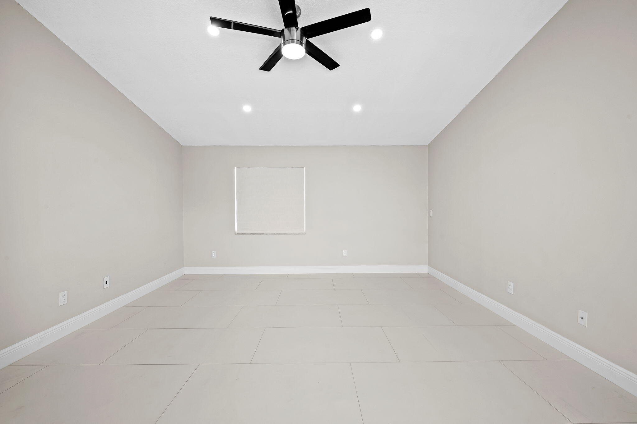 23162 L'Ermitage Circle Boca Raton, FL 33433 - Photo 29 of 48 an empty room with a ceiling fan and window