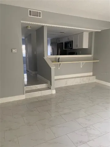 a view of a living room with a large window and furniture