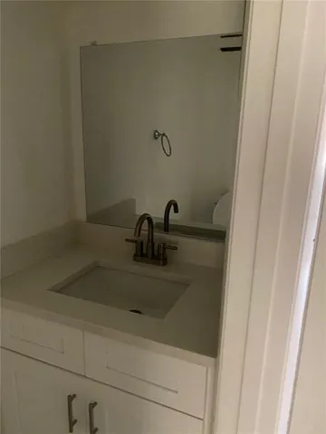 a bathroom with a sink and mirror