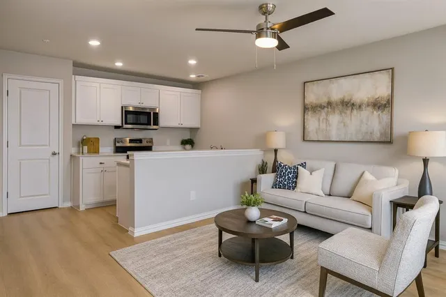 a living room with furniture and kitchen view