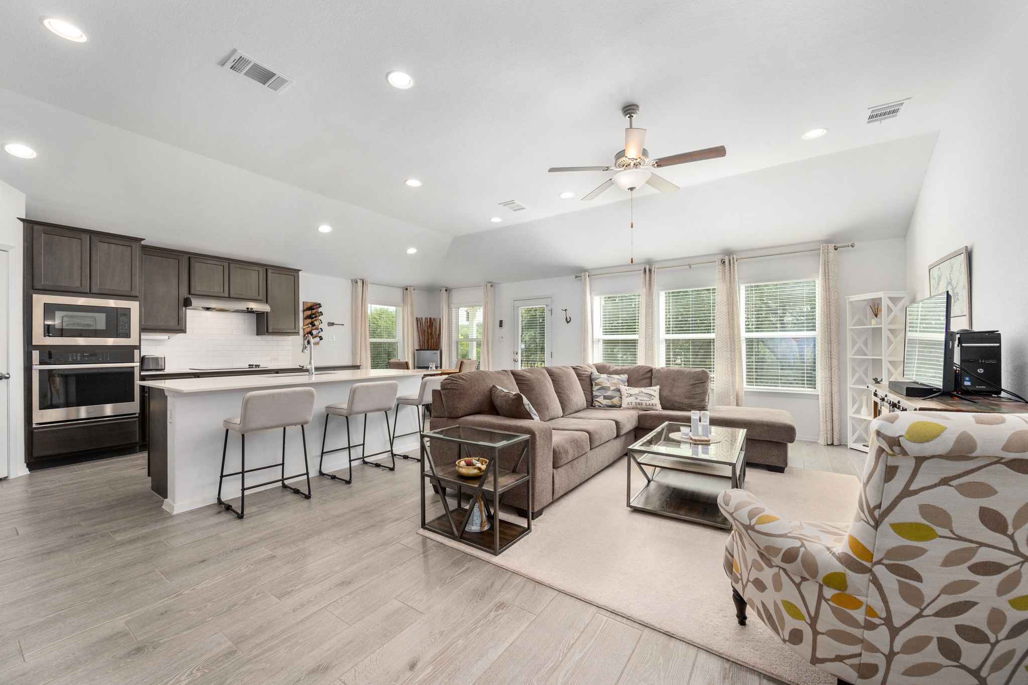 21006 Santa Rosa Avenue Lago Vista, TX 78645 - Photo 5 of 26 An open concept living area seamlessly blends a contemporary kitchen with an inviting lounge space.