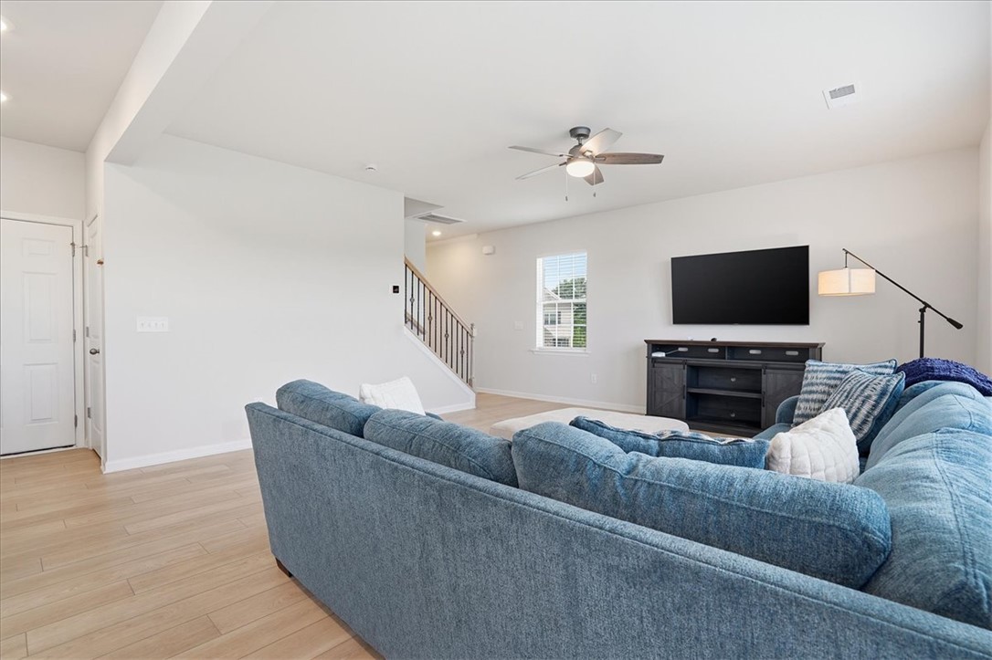 365 Sliding Rock Drive Pendleton, SC 29670 - Photo 15 of 46 A well-lit great room features light-toned flooring, a convenient ceiling fan, and access to an upper level.