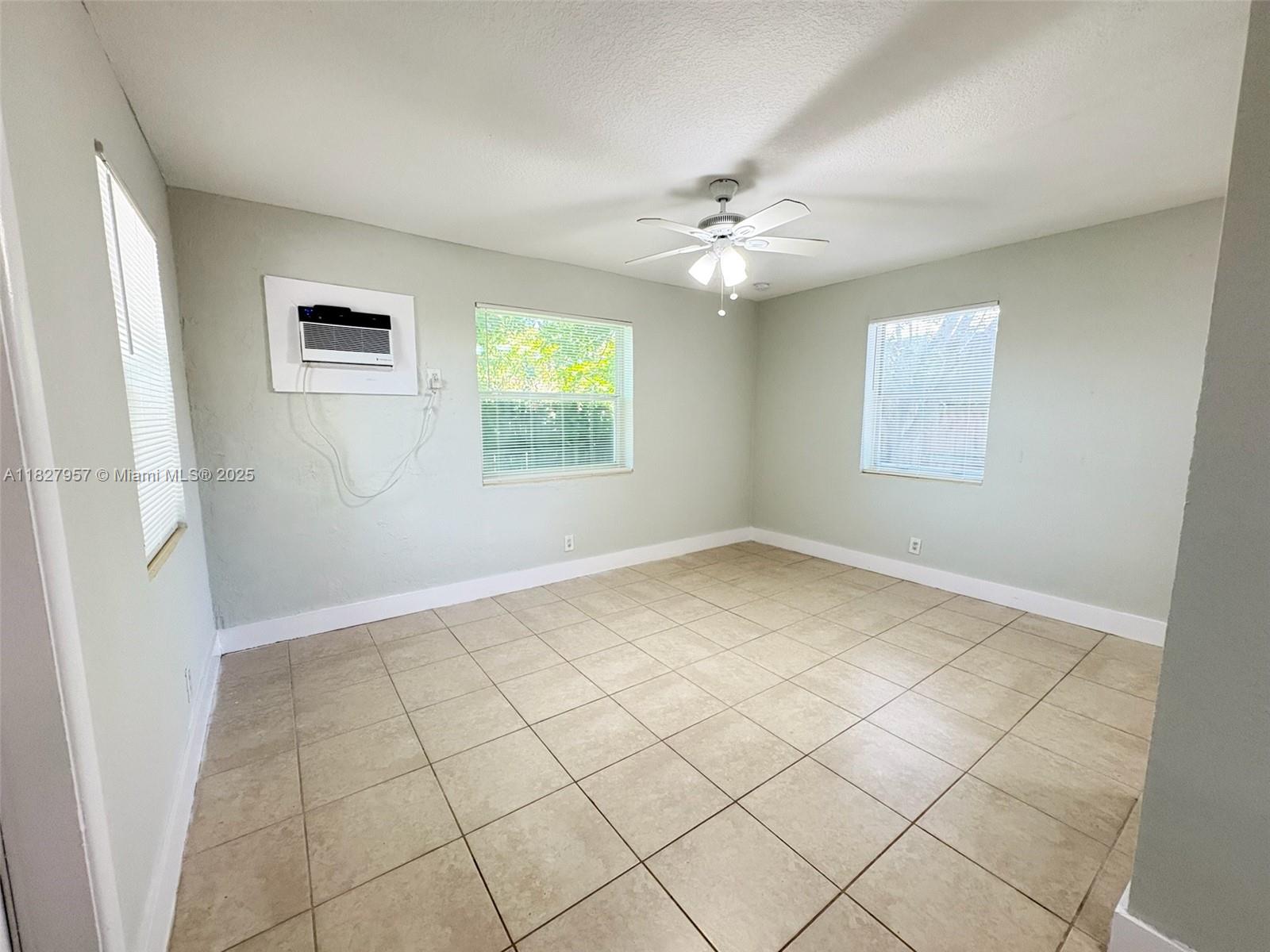 2840 Funston Street, Unit B Hollywood, FL 33020 - Photo 3 of 10 an empty room with windows and fan