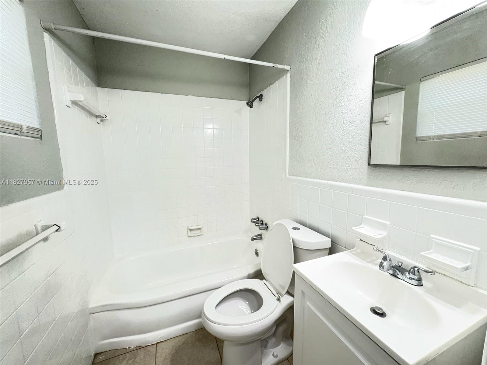 2840 Funston Street, Unit B Hollywood, FL 33020 - Photo 5 of 10 a white toilet sitting next to a bathroom sink